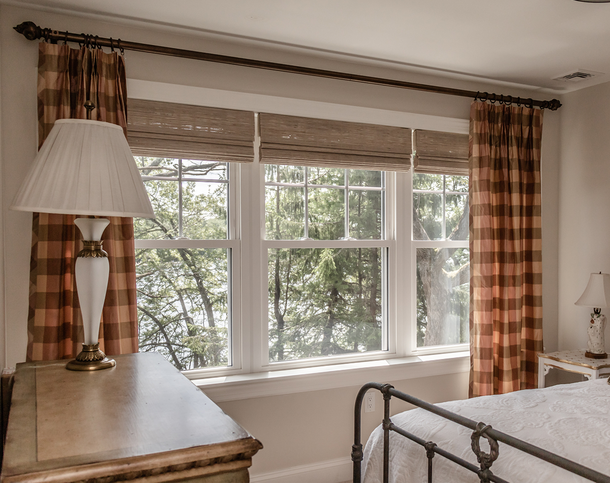 row of three single hung white windows with SDLs on their top sashes